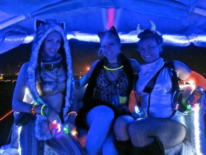Ava Apollo sitting in an art car at Burning Man