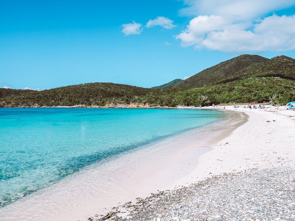 Bright blue, clear water against white sand at Salt Pond Beach