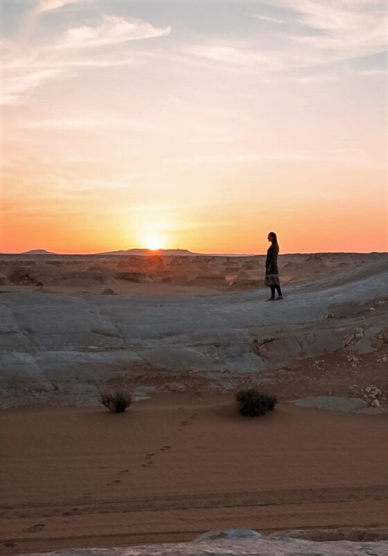 Monica in the Sahara Desert at sunset.